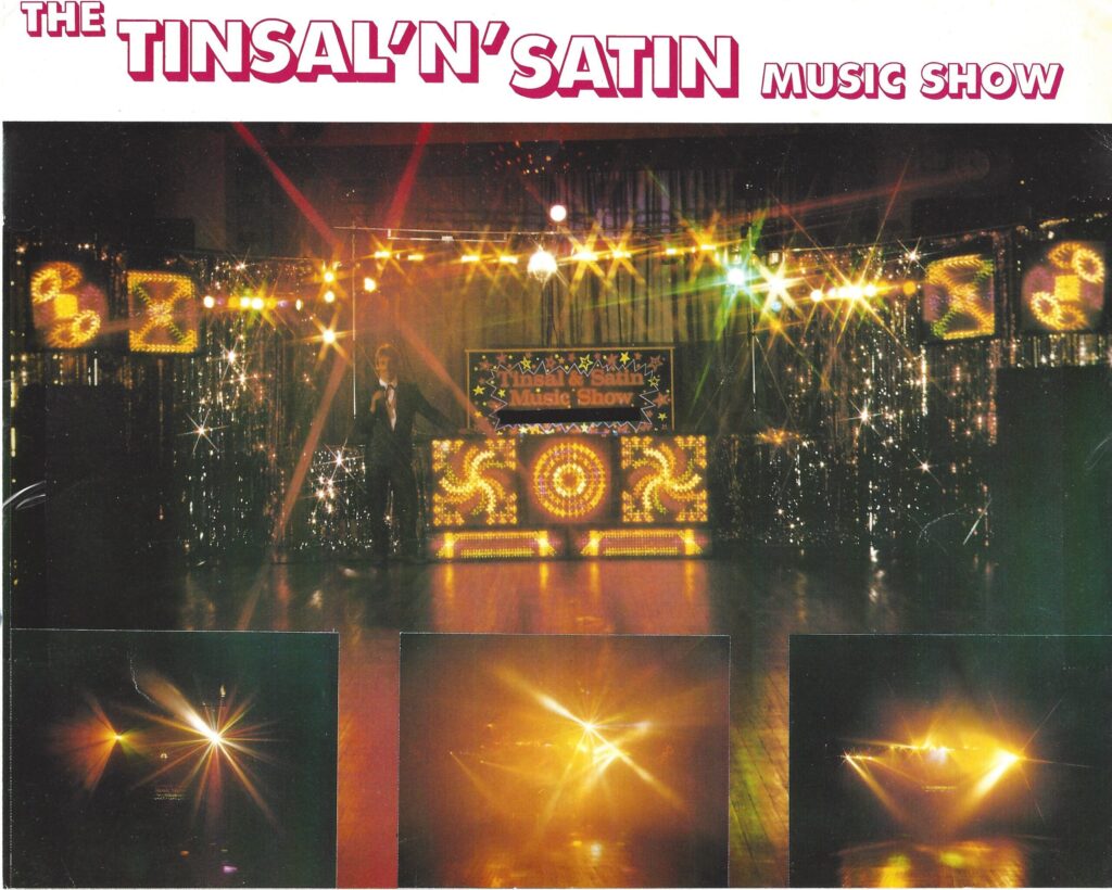 Vintage 1980s mobile disco setup by DJ Tim called The Tinsal 'N' Satin Music Show, featuring an authentic retro light show with a tinsel backdrop and starburst light effects on a wooden dancefloor.