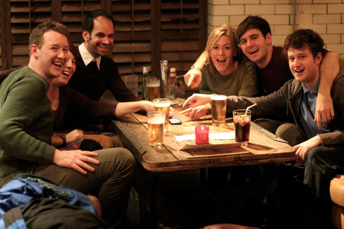 Guests laughing together while playing Boogie Bingo at a pub table