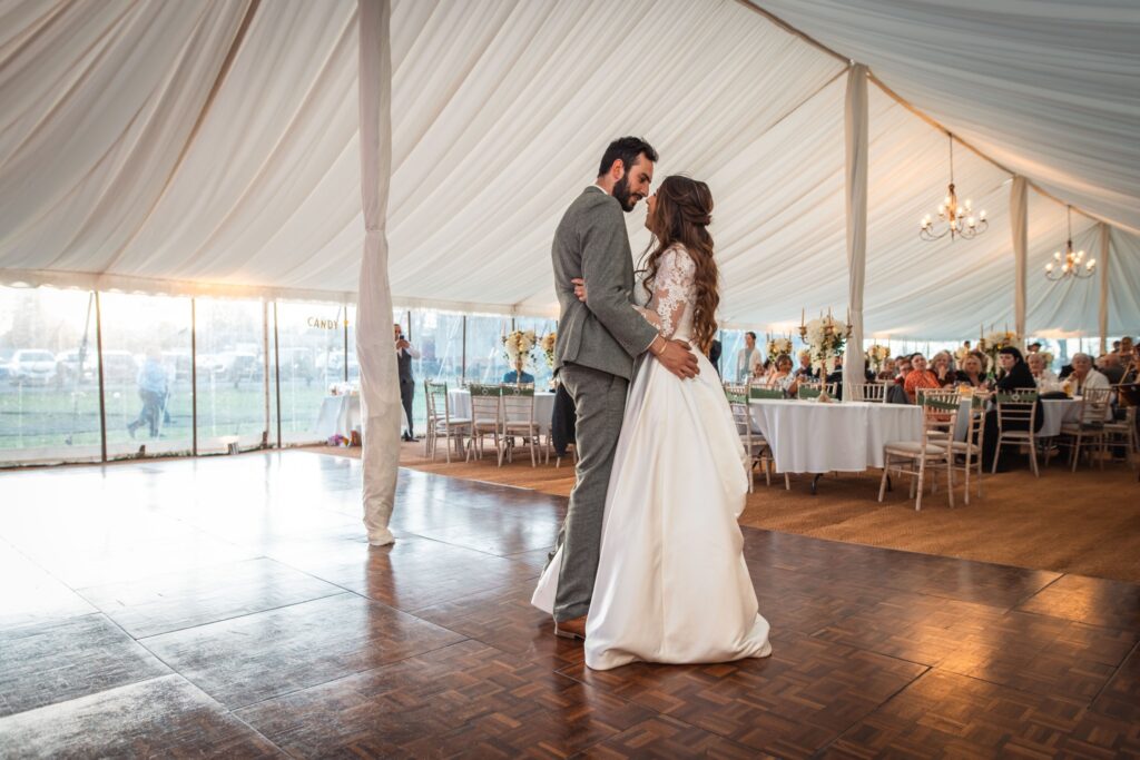 Booking wedding DJ Cambridgeshire — couple first dance at East Anglia wedding reception with DJ Tim providing professional entertainment across four counties