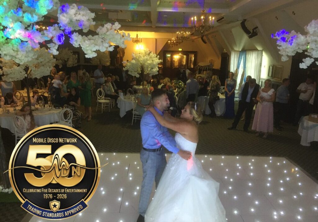 Wedding DJ at Dunston Hall Norwich performing for a first dance on a white starlit dancefloor.