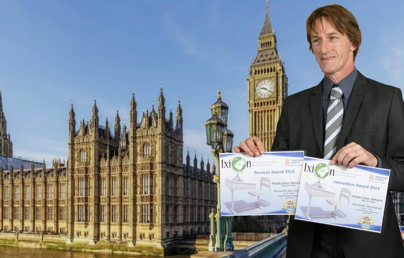 Tim Daymond standing inside Westminster holding his Parliamentary Recognition Award certificate